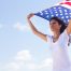 best ways to bring spouse to US wife holding USA flag in her hands